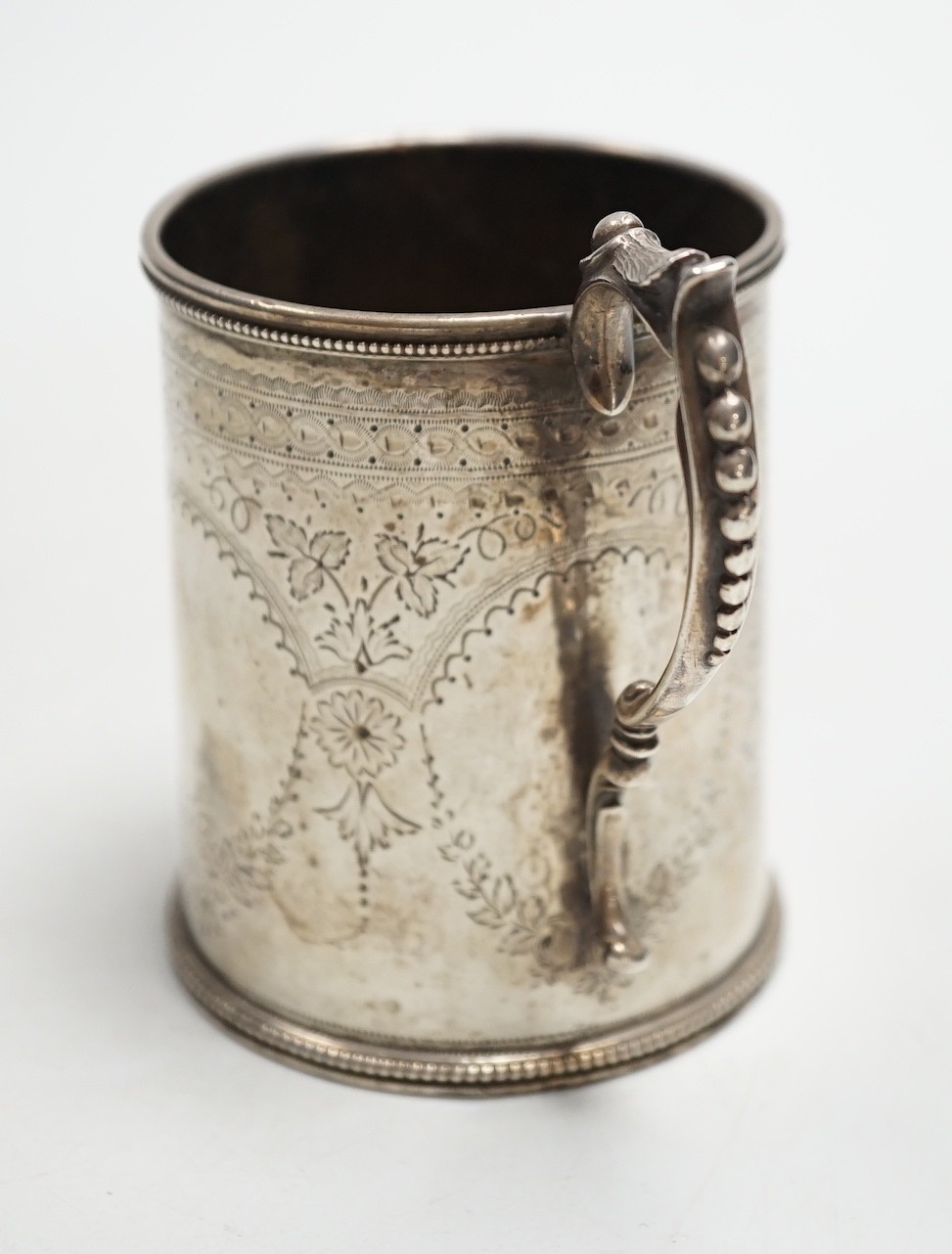 A Victorian engraved silver christening mug, Charles Stuart Harris, London, 1881, height 92mm, with engraved monogram.